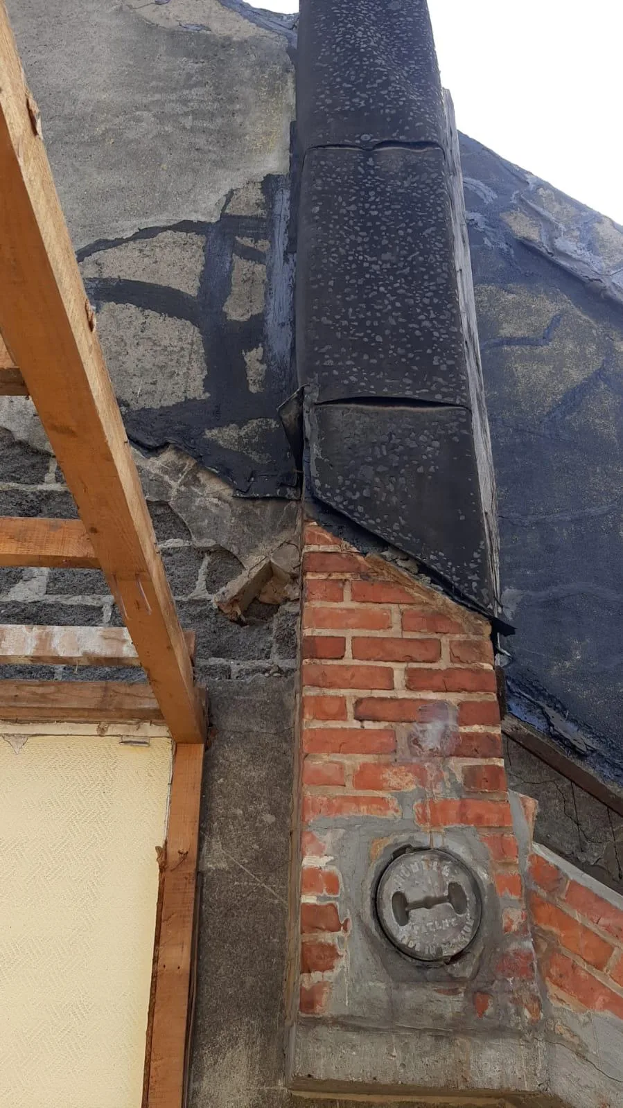 Gevelrenovatie met zicht op blootgelegde bakstenen en reparatiewerkzaamheden aan de muur